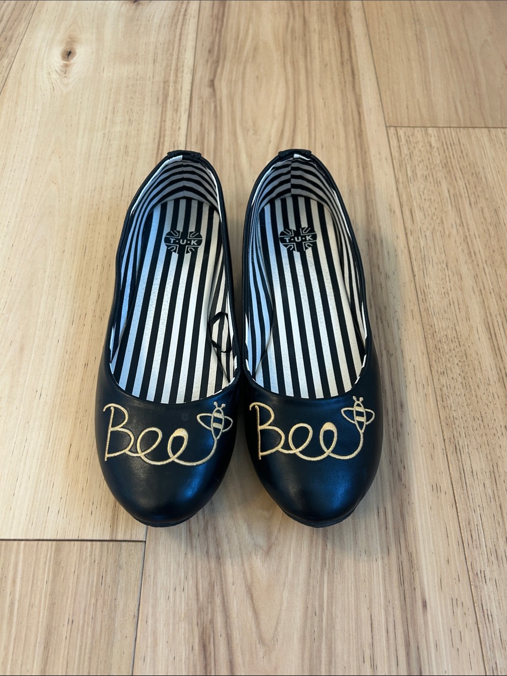 T.U.K Black Ballet Flats with Gold Bee Script Accent
